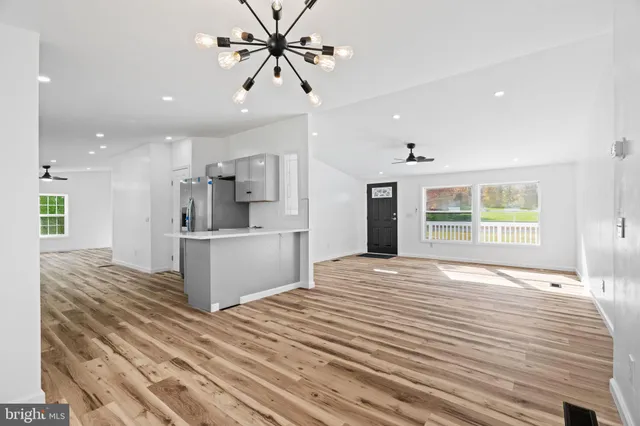 a kitchen with stainless steel appliances a refrigerator and a stove