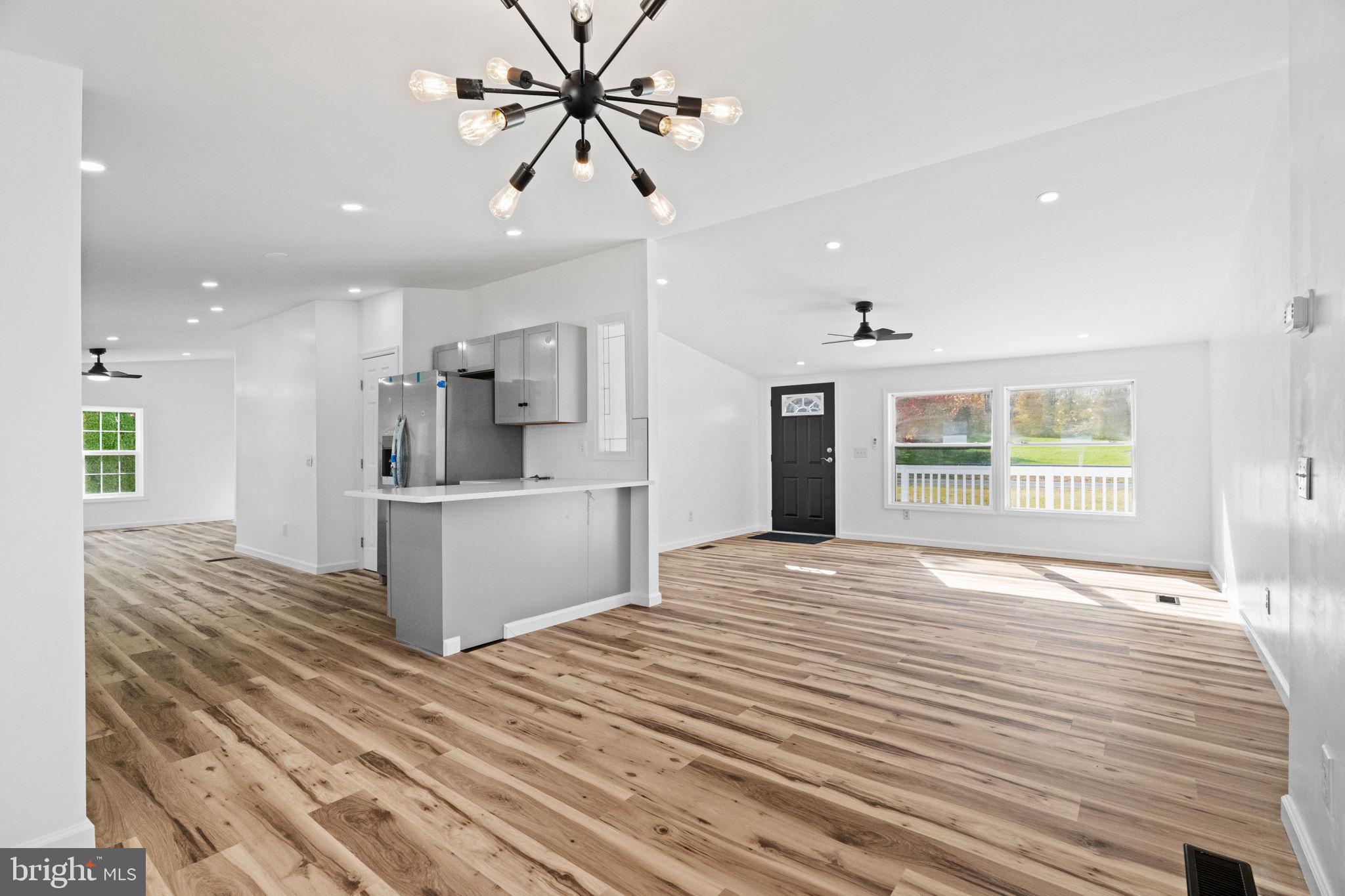 2337 Brownsville Road Robesonia, PA 19551 - Photo 18 of 57 a view of a kitchen with kitchen island a sink wooden floor and a refrigerator