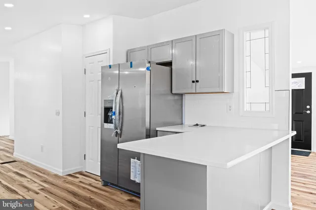 a kitchen with cabinets stainless steel appliances and a counter space