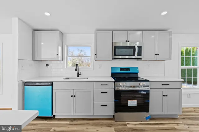 a kitchen with cabinets appliances and a counter space