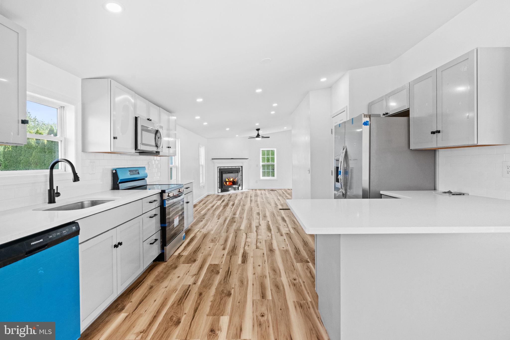 2337 Brownsville Road Robesonia, PA 19551 - Photo 21 of 57 a large white kitchen with kitchen island a sink stainless steel appliances and cabinets