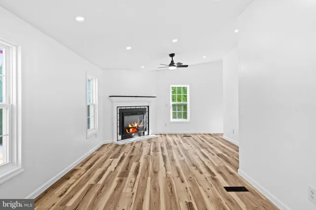 a view of a kitchen with a sink and dishwasher a refrigerator with wooden floor
