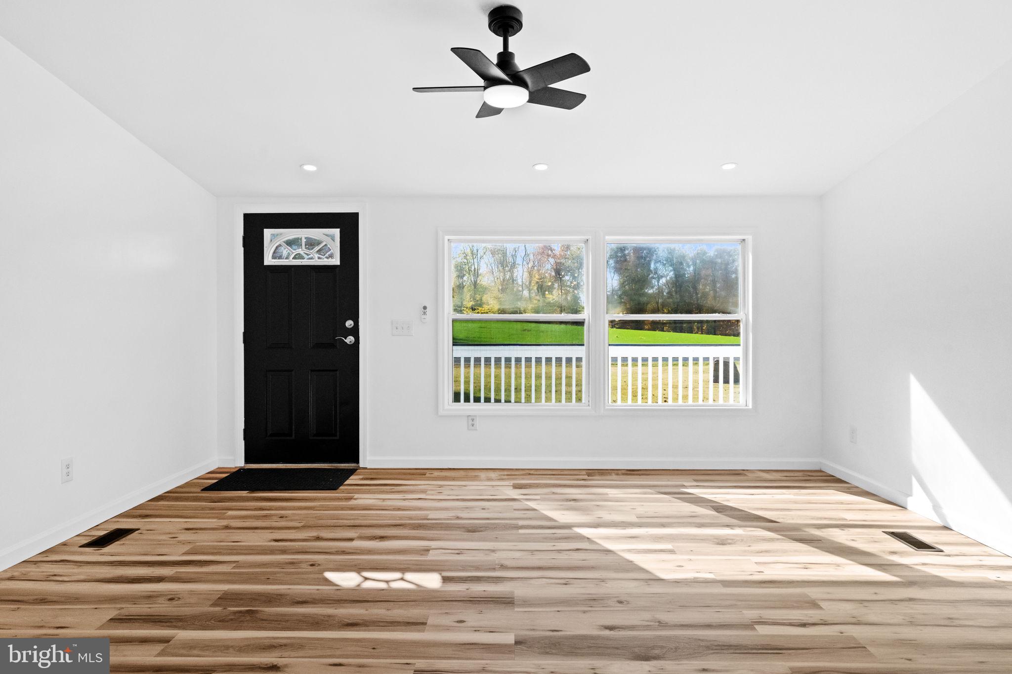 2337 Brownsville Road Robesonia, PA 19551 - Photo 9 of 57 a view of an empty room with a window and wooden floor
