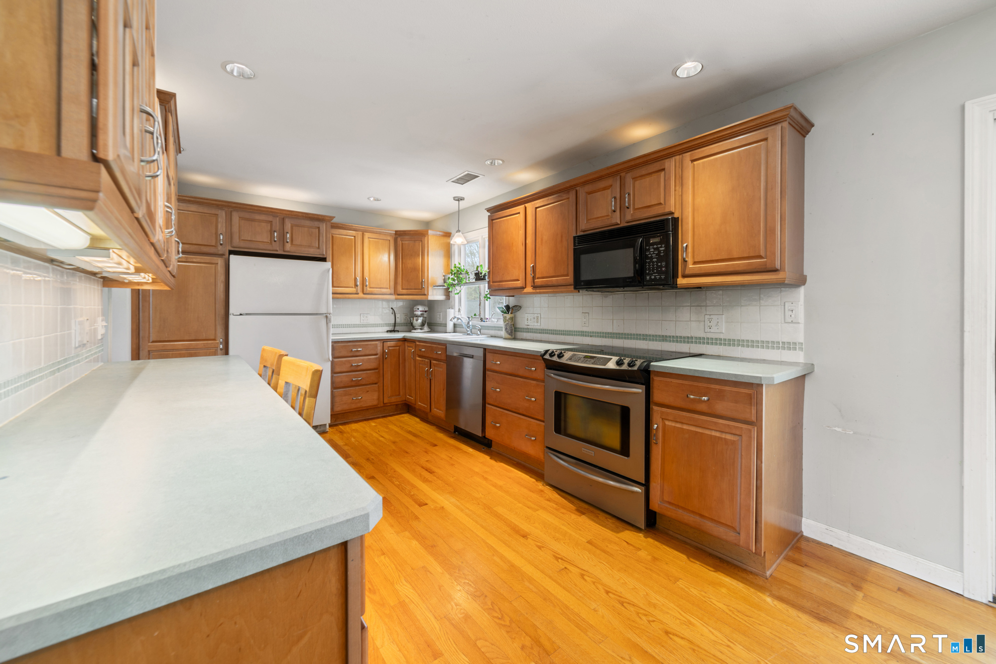 51 Sky View Circle Hamden, CT 06514 - Photo 3 of 40 a kitchen with stainless steel appliances granite countertop a stove a sink and a microwave