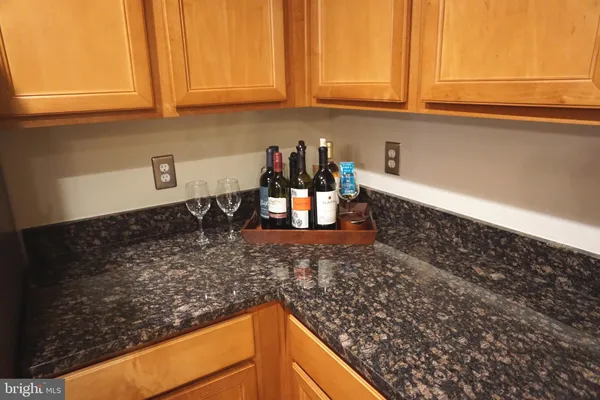a kitchen with granite countertop a sink and cabinets