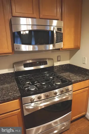 a stove top oven sitting inside of a kitchen