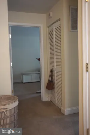 a view of a room that has a door and a window