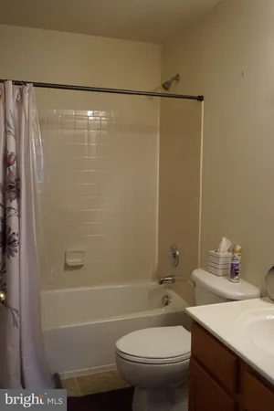 a bathroom with a shower a toilet and sink