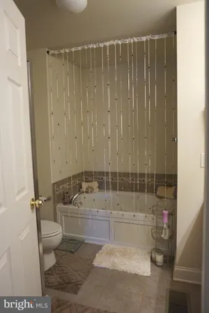 a bathroom with a toilet and shower