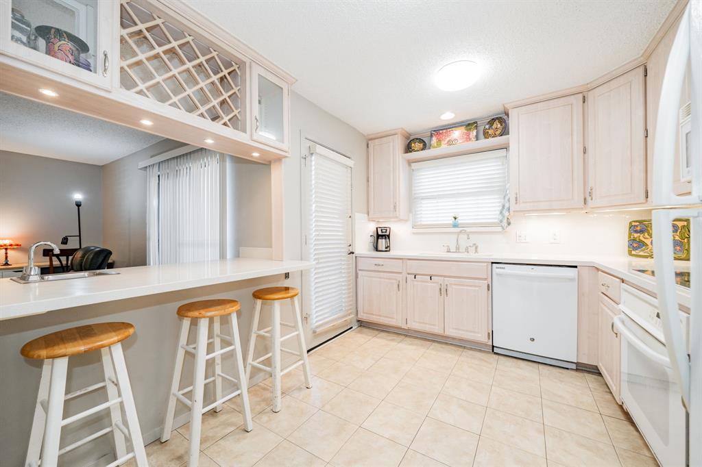 a kitchen with a stove a sink and cabinets