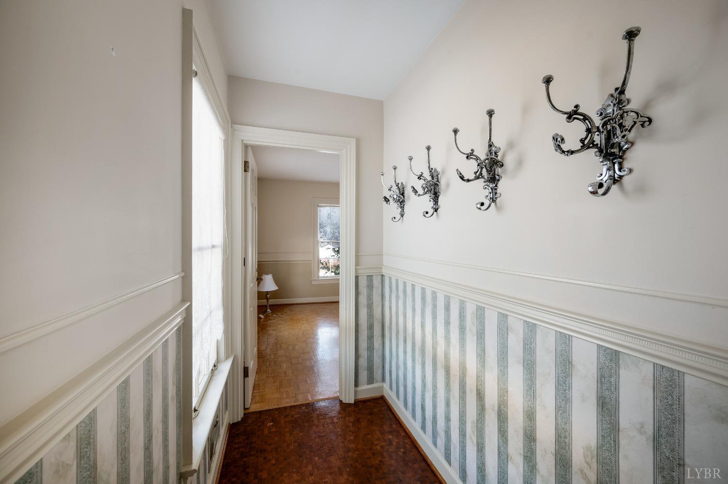 211 Sunset Drive Amherst, VA 24521 - Photo 21 of 76 a view of a hallway to a livingroom with wooden floor and stairs