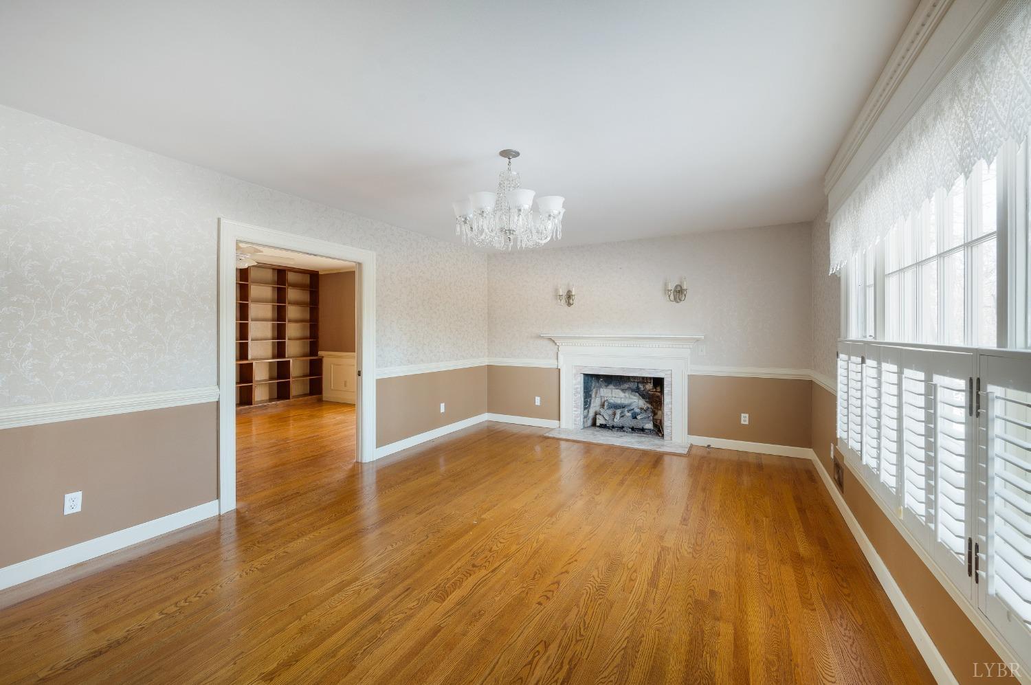 211 Sunset Drive Amherst, VA 24521 - Photo 22 of 76 wooden floor fireplace and windows in an empty room