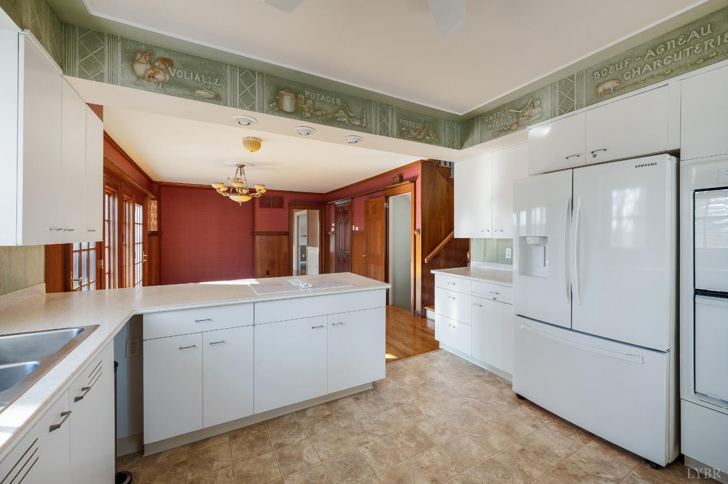 211 Sunset Drive Amherst, VA 24521 - Photo 30 of 76 a large white kitchen with a large window a refrigerator and a sink
