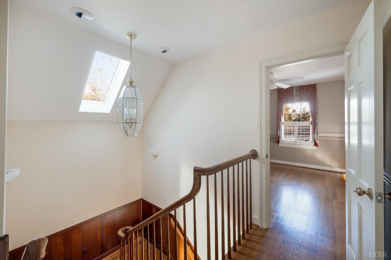 211 Sunset Drive Amherst, VA 24521 - Photo 33 of 76 a view of a hallway with wooden floor and stairs