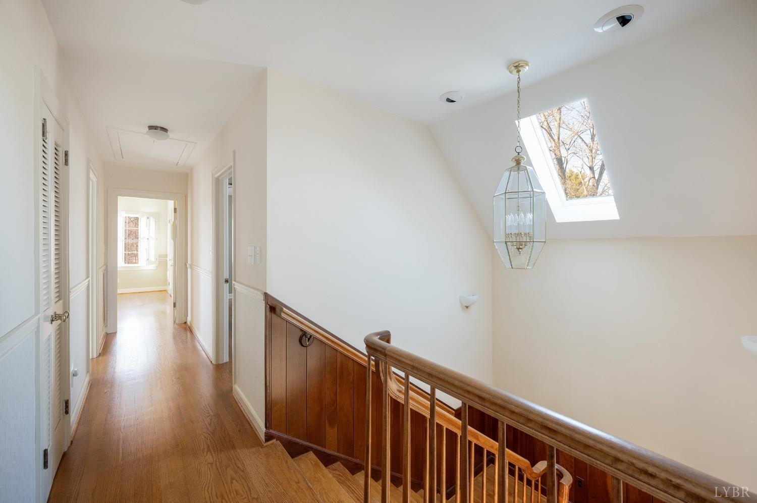 211 Sunset Drive Amherst, VA 24521 - Photo 34 of 76 a view of a hallway with wooden floor and staircase
