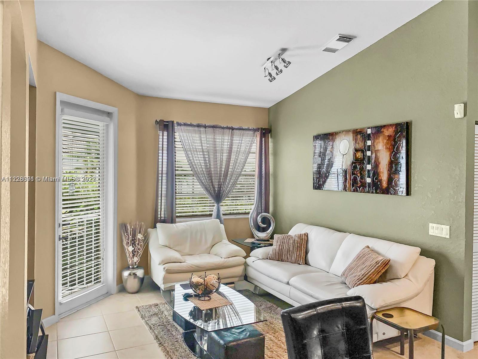 3150 Laurel Ridge Circle, Unit 3150 Riviera Beach, FL 33404 - Photo 1 of 18 a living room with furniture and a window