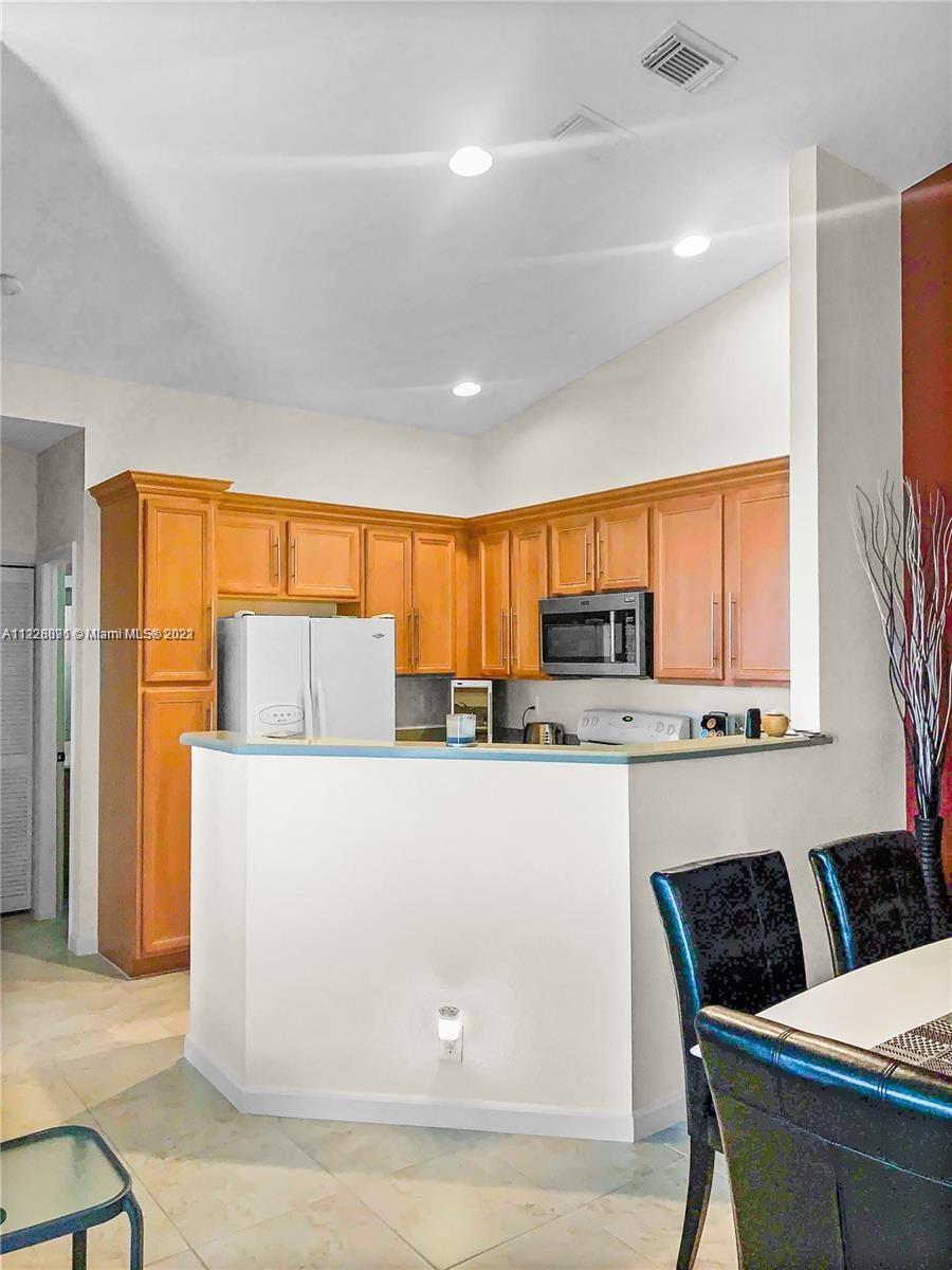 3150 Laurel Ridge Circle, Unit 3150 Riviera Beach, FL 33404 - Photo 11 of 18 a living room with stainless steel appliances kitchen island granite countertop furniture and a large window