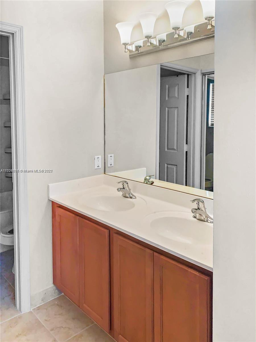 3150 Laurel Ridge Circle, Unit 3150 Riviera Beach, FL 33404 - Photo 7 of 18 a bathroom with a sink and a mirror
