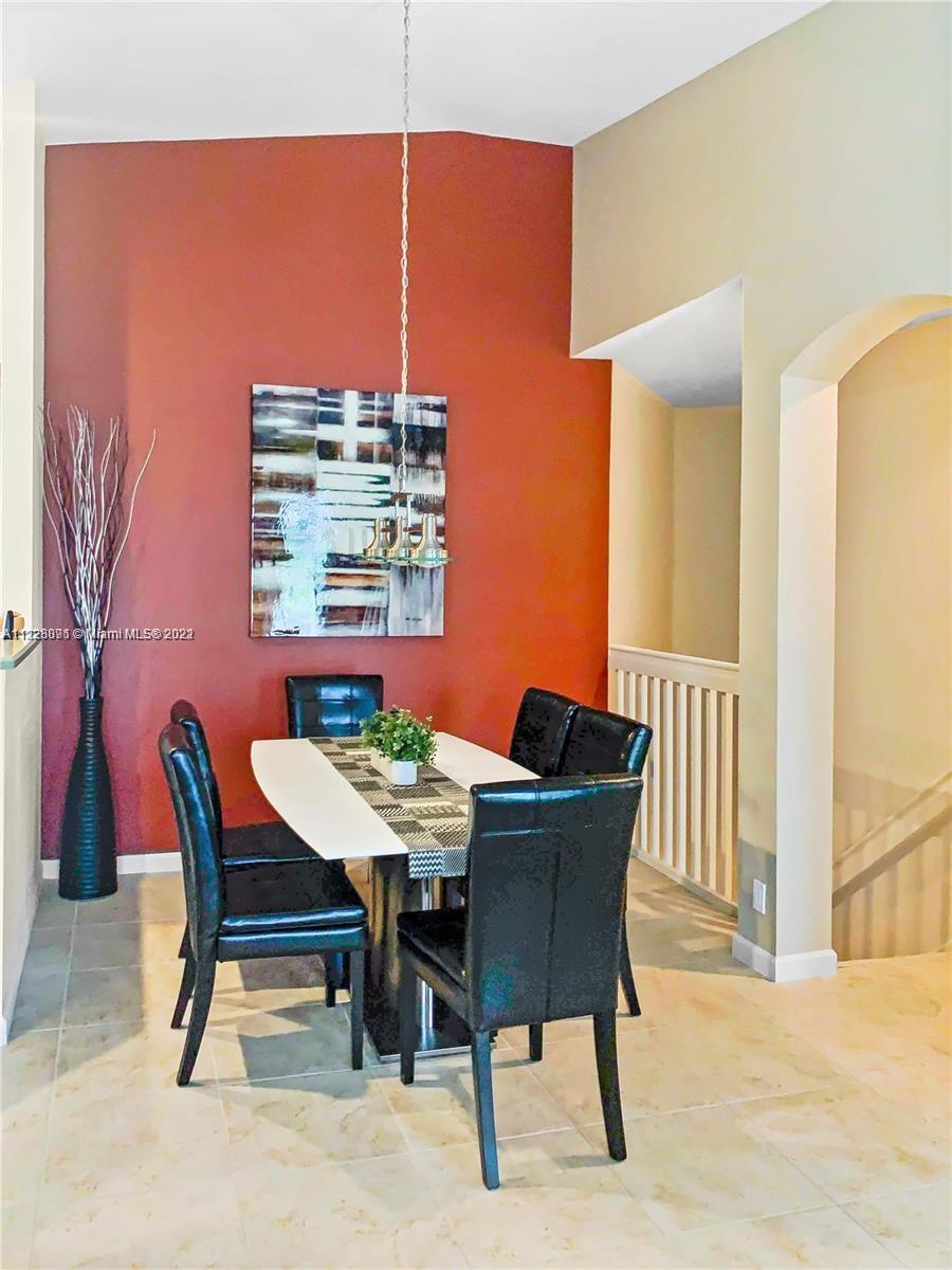 3150 Laurel Ridge Circle, Unit 3150 Riviera Beach, FL 33404 - Photo 8 of 18 a view of a dining room with furniture and a large window