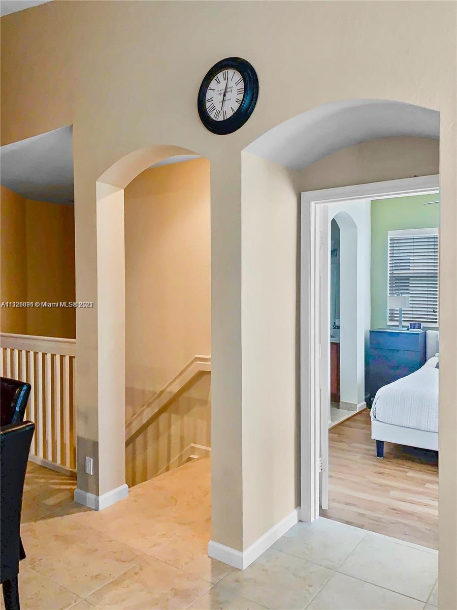 3150 Laurel Ridge Circle, Unit 3150 Riviera Beach, FL 33404 - Photo 9 of 18 a view of a hallway with entryway wooden floor and front door