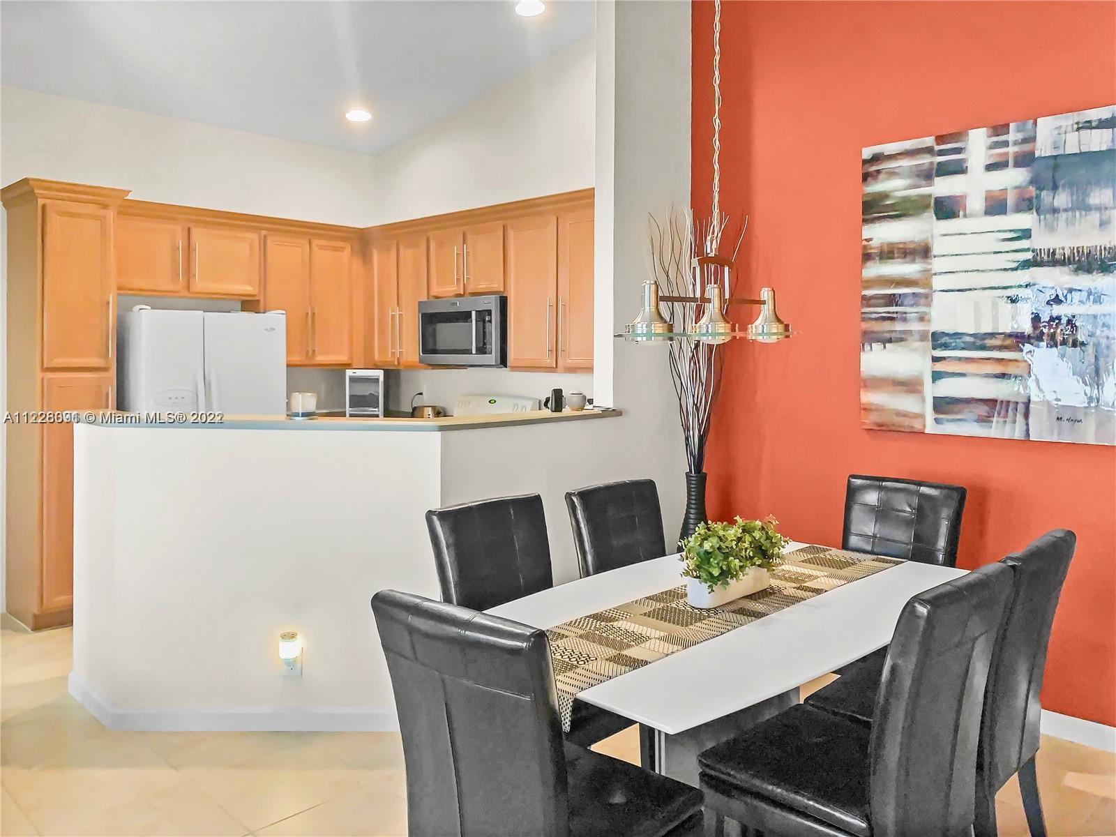 3150 Laurel Ridge Circle, Unit 3150 Riviera Beach, FL 33404 - Photo 10 of 18 a dining room with furniture and window