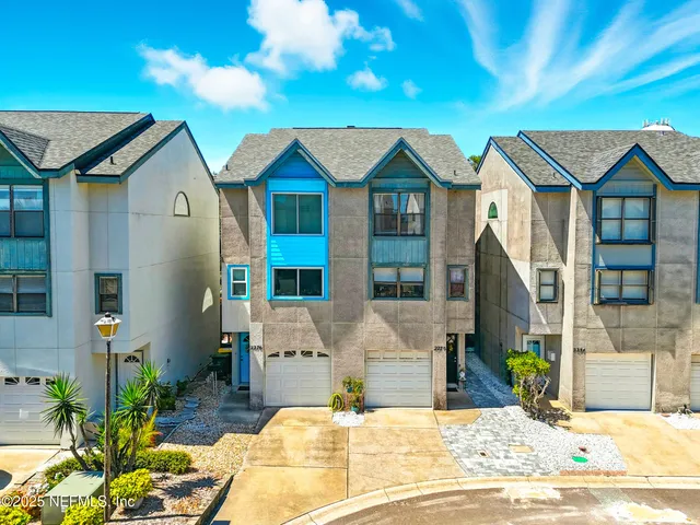 a view of multiple houses with a street