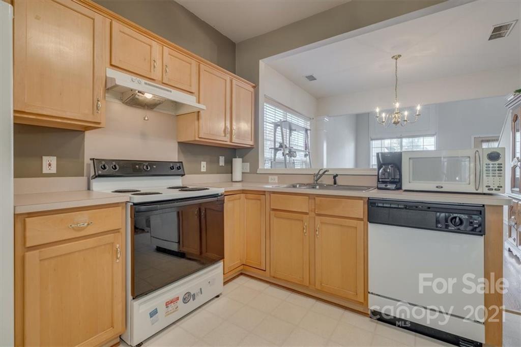 14014 Dingess Road Charlotte, NC 28273 - Photo 15 of 38 a kitchen with granite countertop a sink stainless steel appliances and cabinets