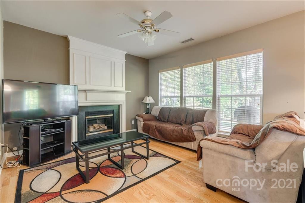 14014 Dingess Road Charlotte, NC 28273 - Photo 18 of 38 a living room with furniture a flat screen tv and a fireplace