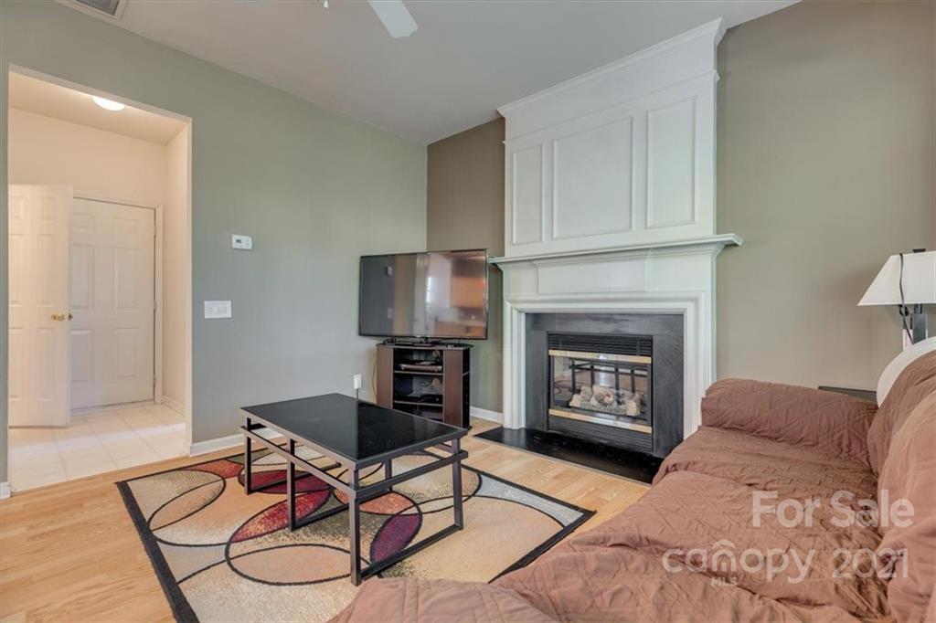14014 Dingess Road Charlotte, NC 28273 - Photo 20 of 38 a living room with furniture a fireplace and a flat screen tv