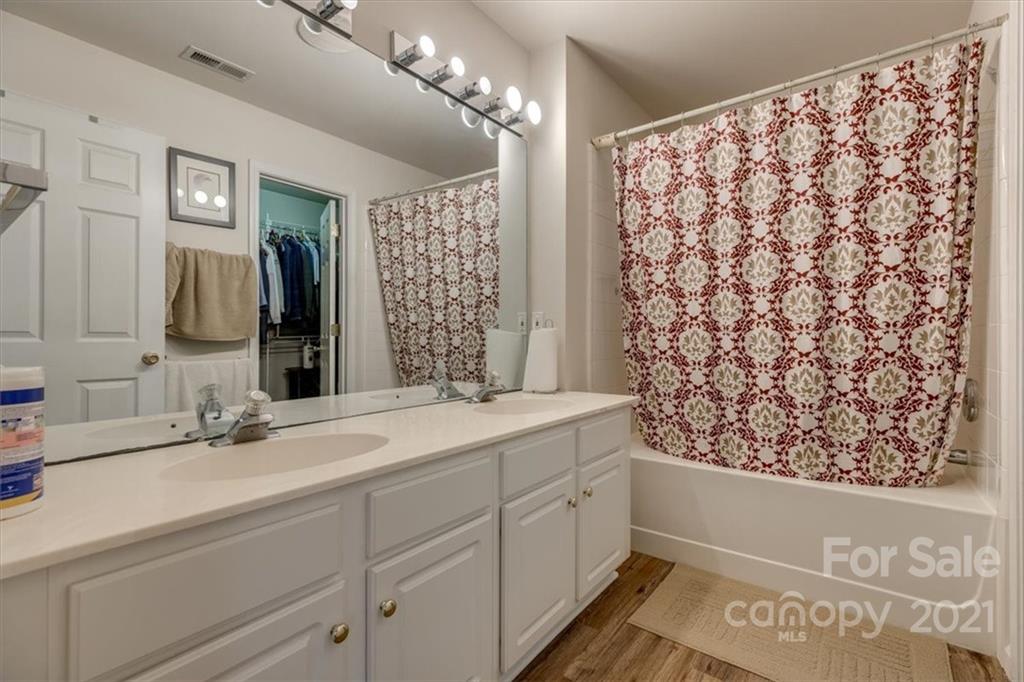 14014 Dingess Road Charlotte, NC 28273 - Photo 25 of 38 a bathroom with a double vanity sink mirror and shower