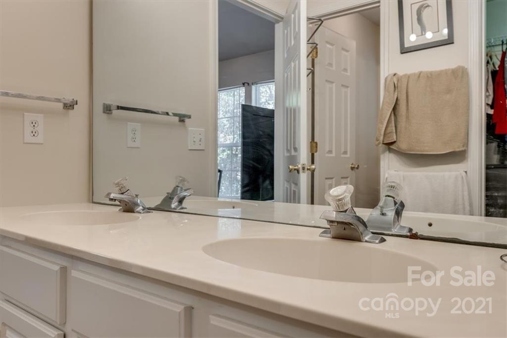 14014 Dingess Road Charlotte, NC 28273 - Photo 26 of 38 a bathroom with a sink and a mirror
