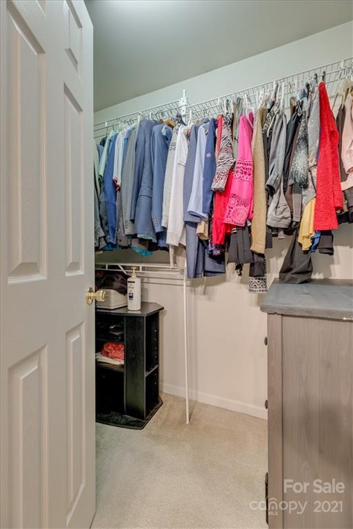 14014 Dingess Road Charlotte, NC 28273 - Photo 28 of 38 a view of walk in closet with clothes