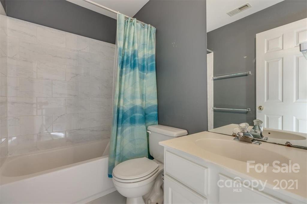 14014 Dingess Road Charlotte, NC 28273 - Photo 29 of 38 a bathroom with a sink toilet and shower