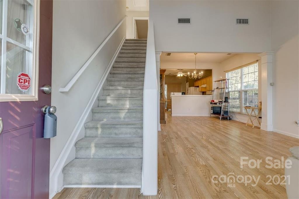 14014 Dingess Road Charlotte, NC 28273 - Photo 6 of 38 a view of an entryway with wooden floor and a livingroom view