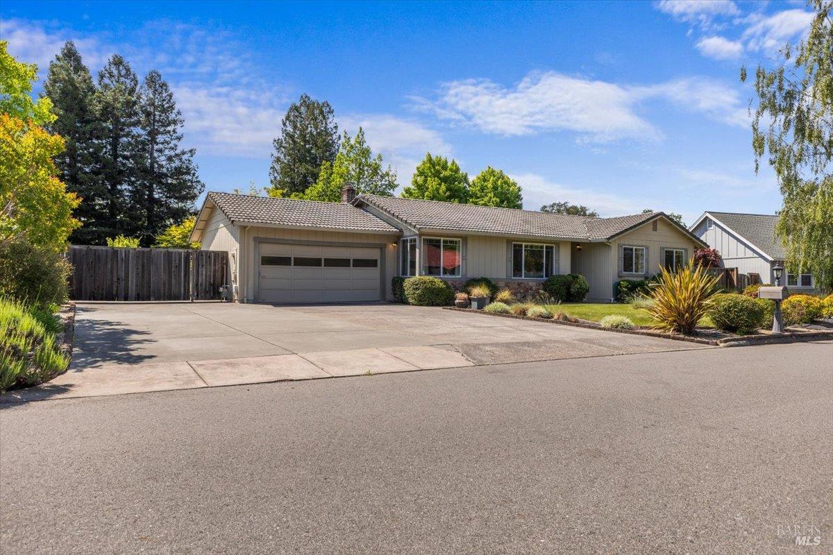 a front view of a house with a yard and a garage