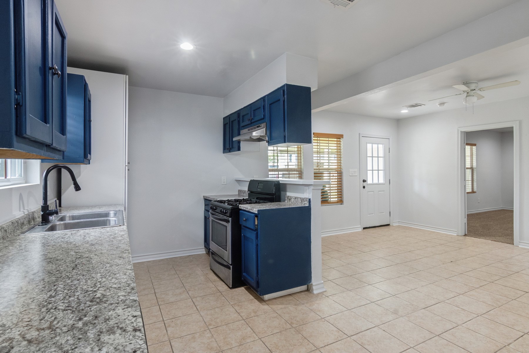 4505 Cochran Street Houston, TX 77009 - Photo 8 of 25 a kitchen with granite countertop a stove and a sink