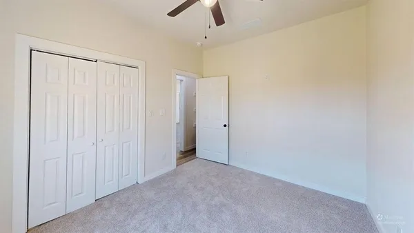 a view of a room with a ceiling fan