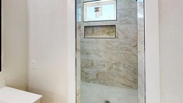a bathroom with a toilet and a shower