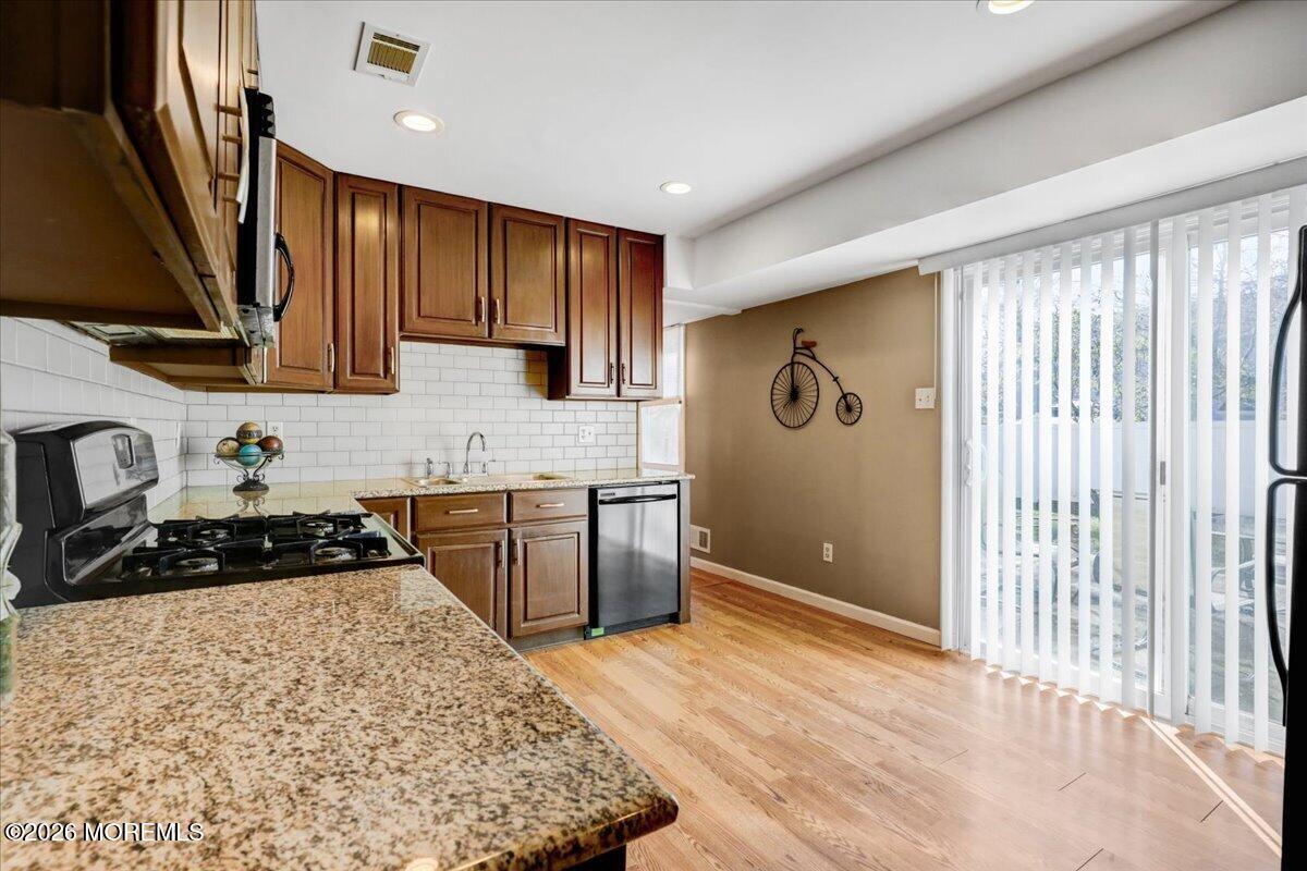 16 Regina Drive Howell, NJ 07731 - Photo 13 of 33 a kitchen with a stove a refrigerator and a sink