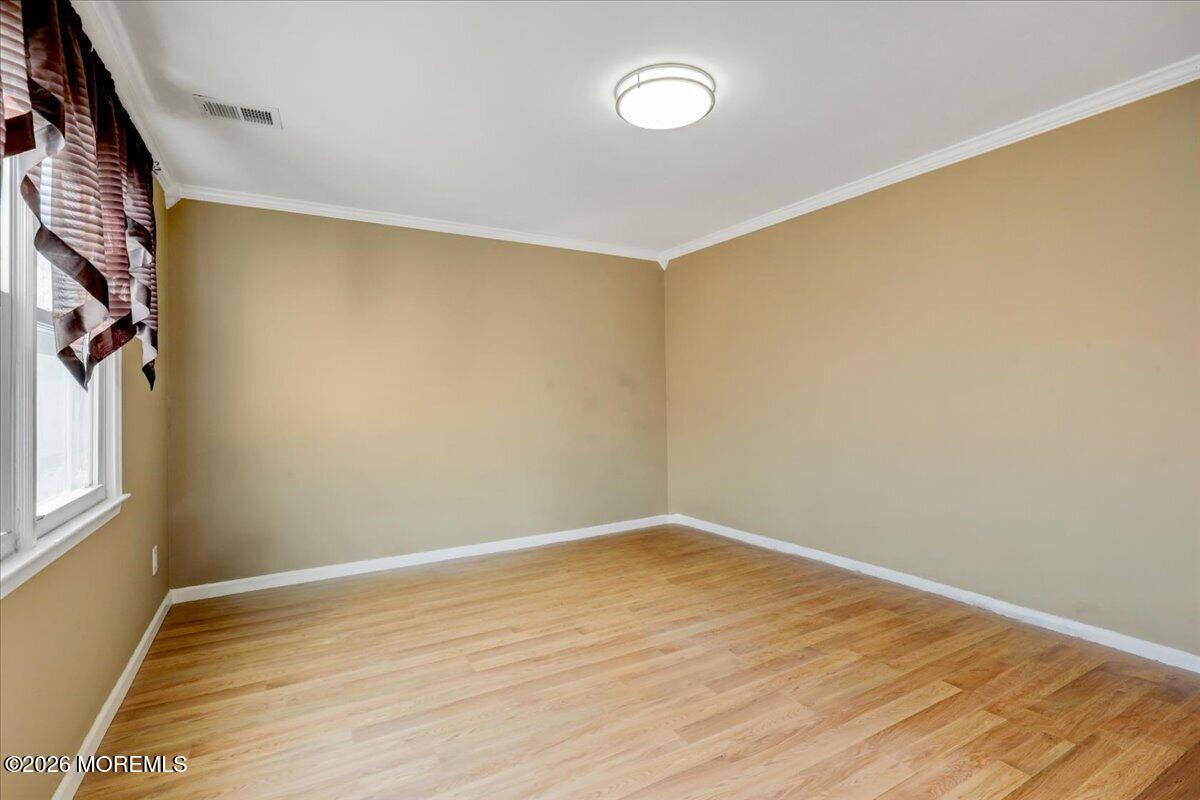 16 Regina Drive Howell, NJ 07731 - Photo 15 of 33 a view of an empty room with wooden floor and a window