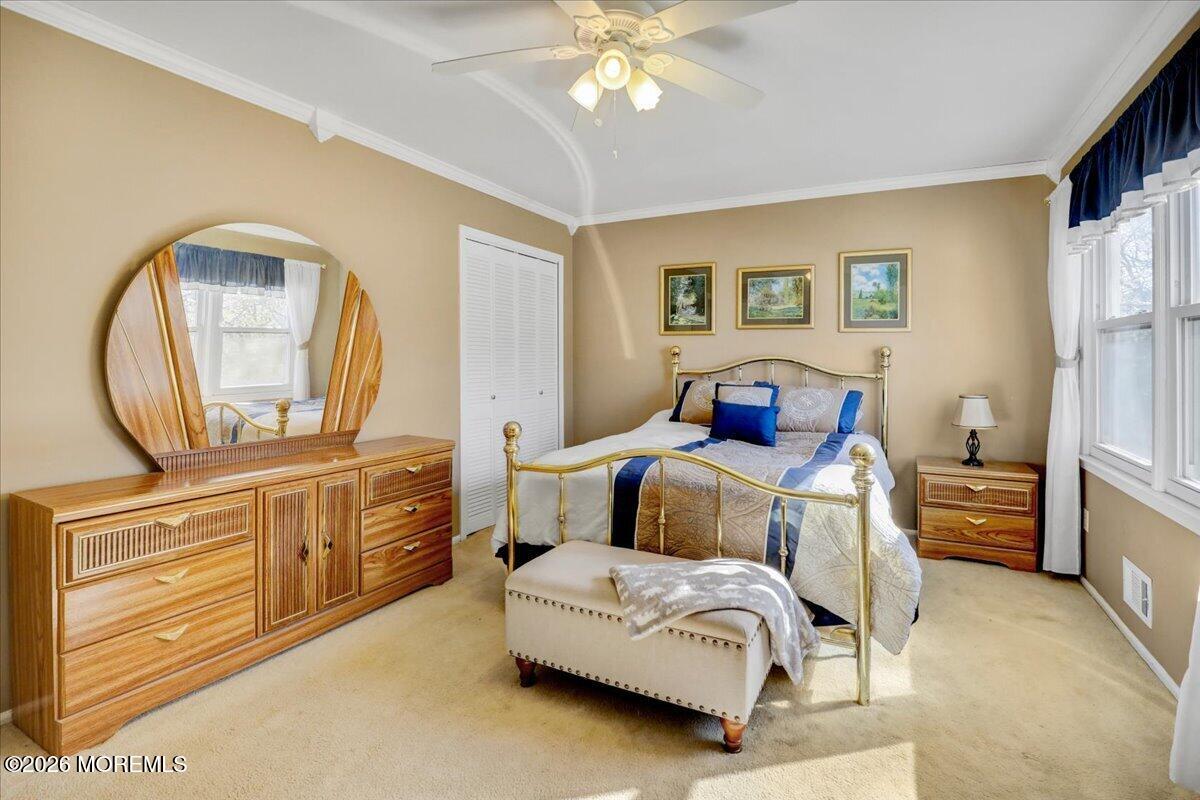 16 Regina Drive Howell, NJ 07731 - Photo 21 of 33 a bedroom with a large bed and a chandelier