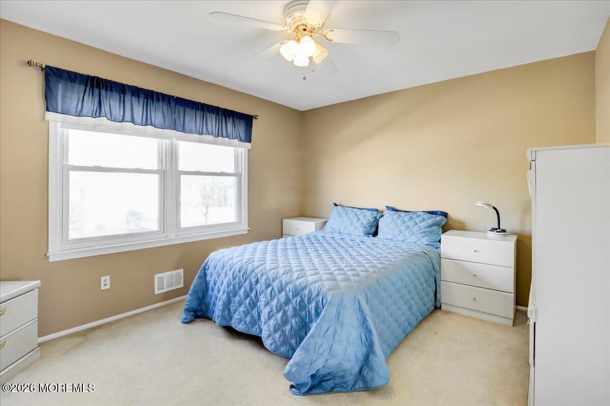 16 Regina Drive Howell, NJ 07731 - Photo 26 of 33 a bedroom with a bed and a chandelier