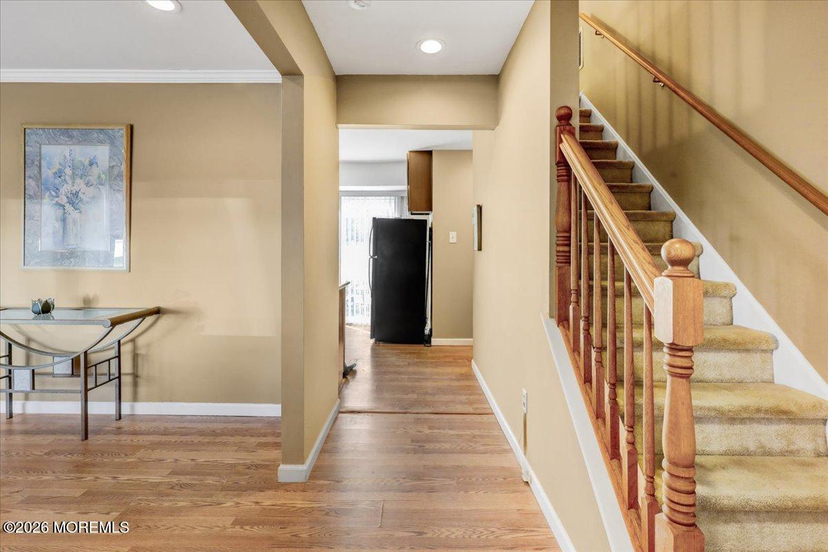 16 Regina Drive Howell, NJ 07731 - Photo 5 of 33 a view of a hallway with wooden floor and staircase