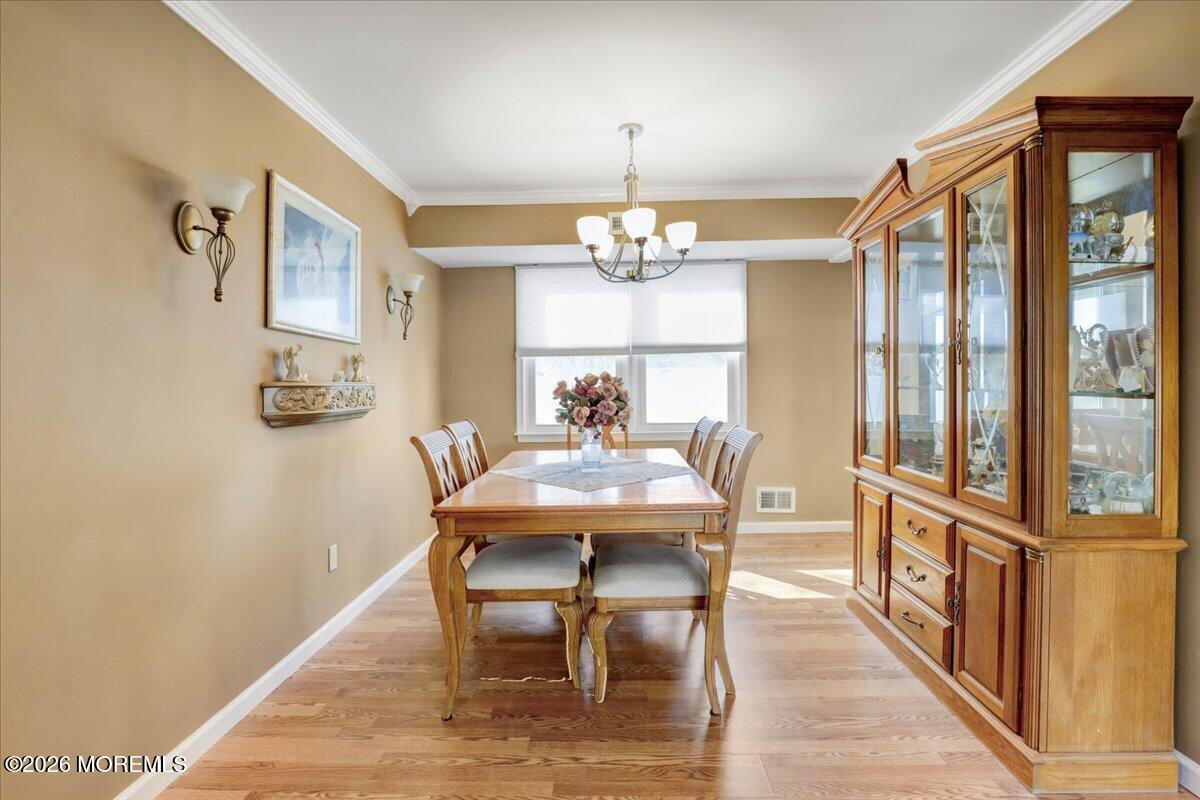 16 Regina Drive Howell, NJ 07731 - Photo 9 of 33 a view of a dining room with furniture a chandelier and wooden floor