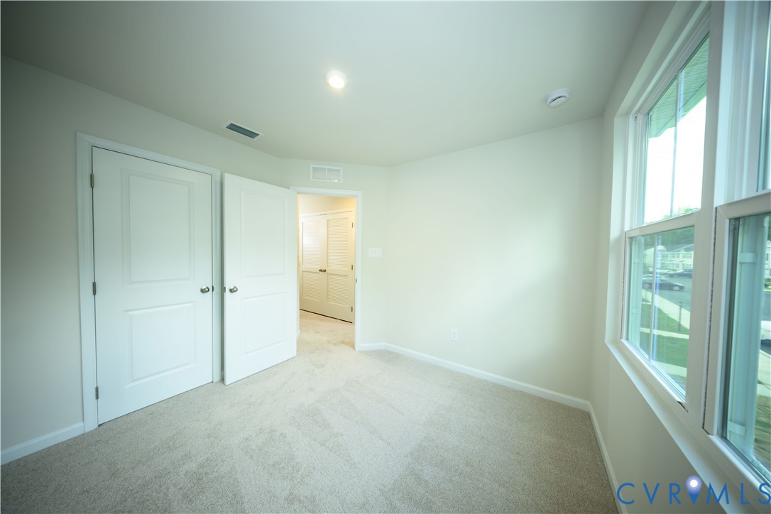 1121 Canterbury Ridge Road Richmond, VA 23224 - Photo 40 of 53 Room featuring carpet flooring, crisp white walls,