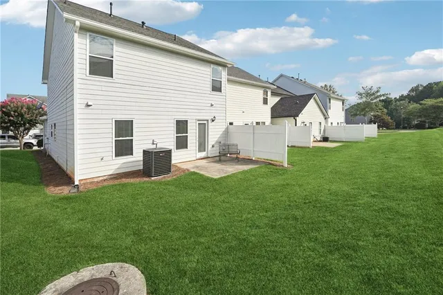 a backyard of a house with table and chairs