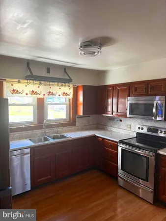 a kitchen with stainless steel appliances granite countertop a sink and stove