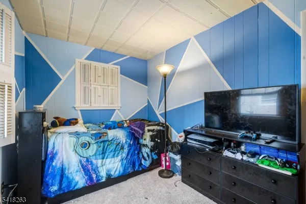 a bedroom with furniture and a flat screen tv