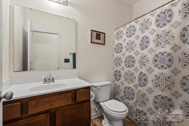 a bathroom with a sink toilet and a mirror