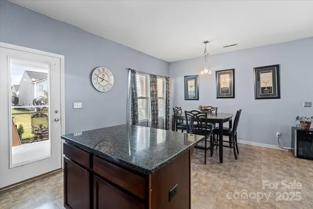 a kitchen with a table and chairs in it